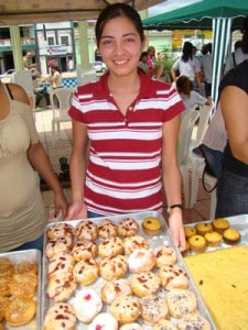 woman holding a tray of baked goods