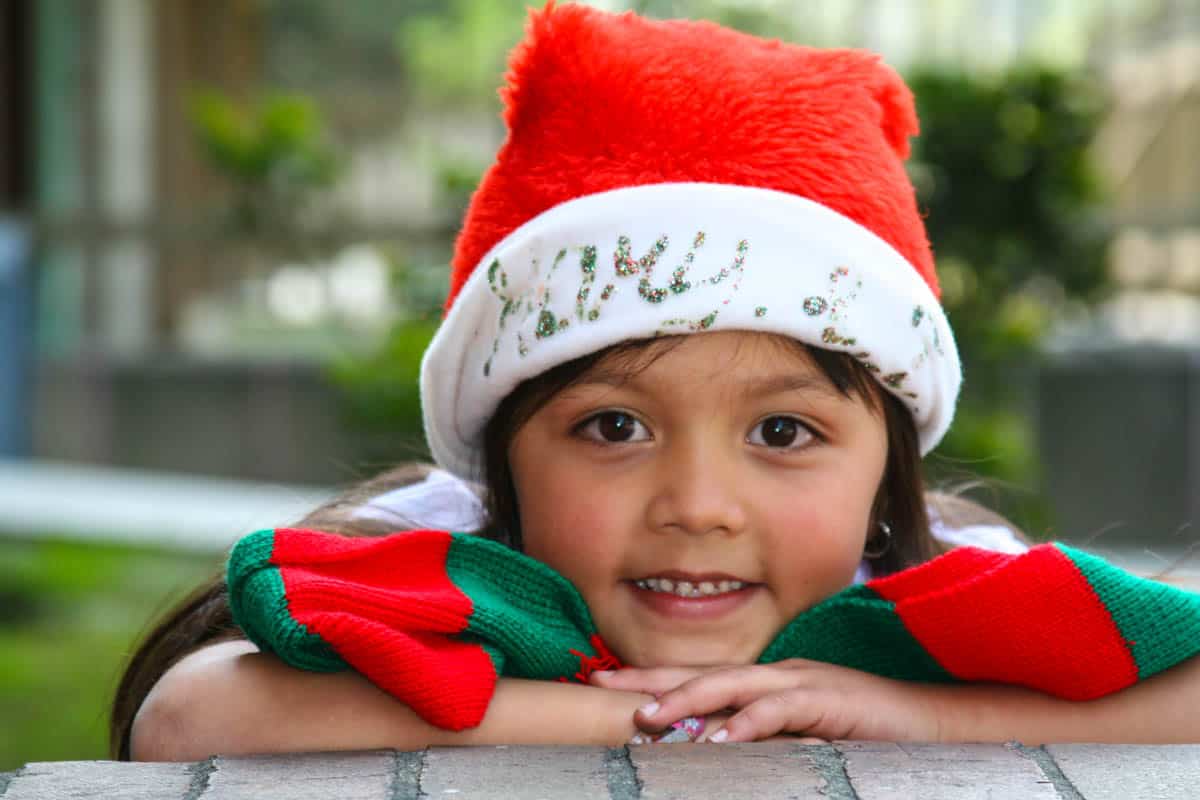 A cute smiling girl wearing a santa hat