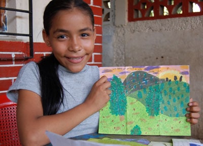 girl holding a drawing