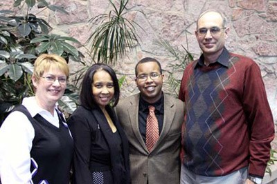 two men and two women posing for photo