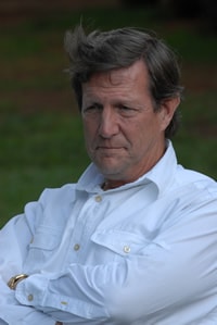 Wess Stafford wearing a white shirt with arms folded