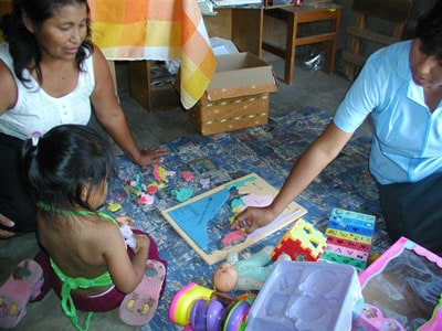 young girl with two adults working on a puzzle