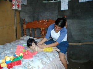 woman rubbing a child's back