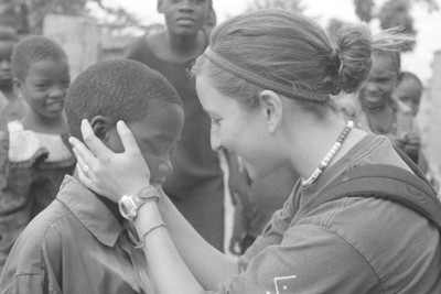 woman embracing a child as other people look on