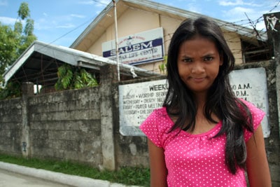 girl standing in front of student center