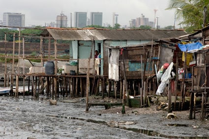 slum community with high rise buildings in the background