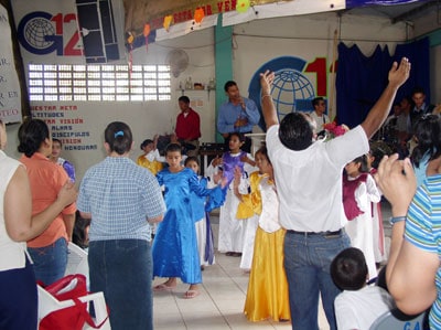 group of adults and children worshiping