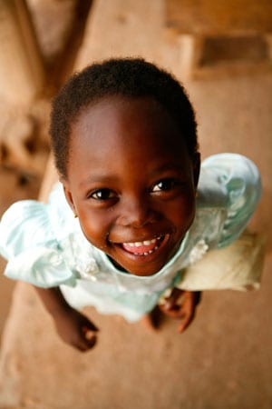 young girl looking up wearing blue dress