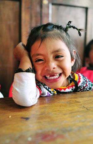 smiling girl with front teeth missing