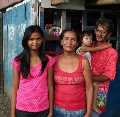 young lady outside home with family members