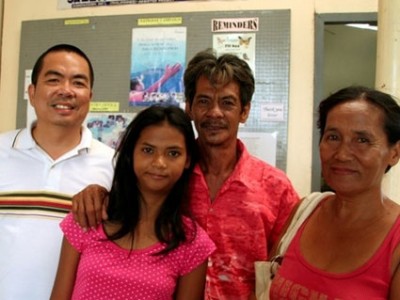 Filipino girl with parents and pastor