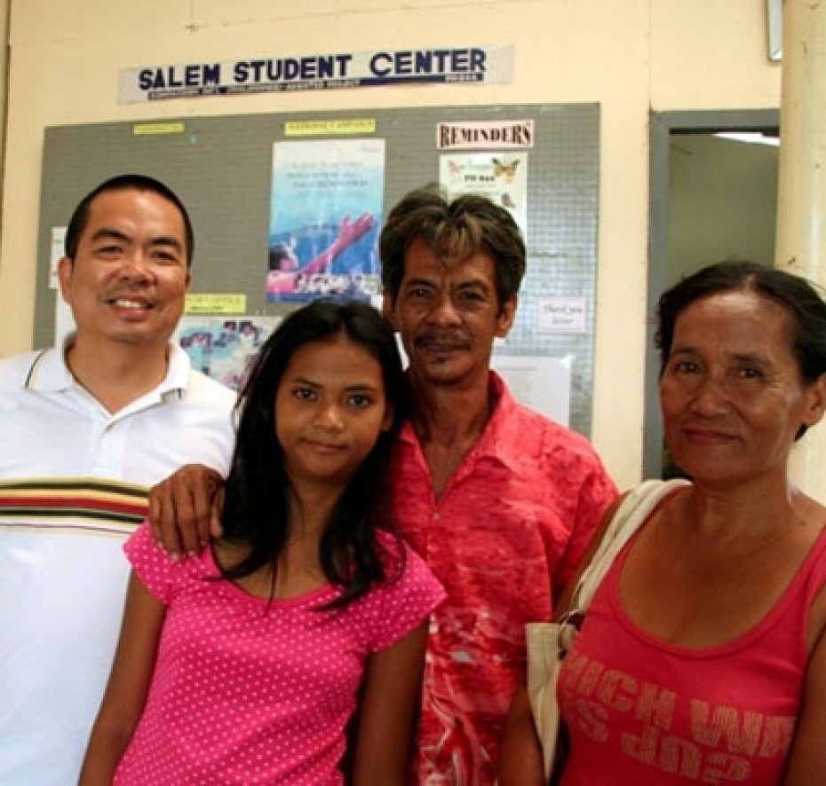 Filipino girl with parents and pastor