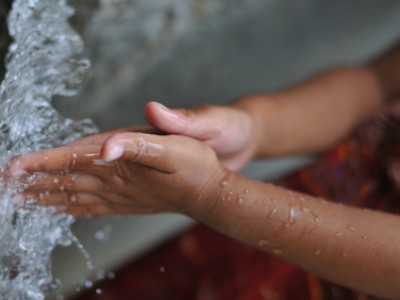 a child washing hands in water