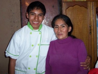 Young boy and woman standing next to each other.