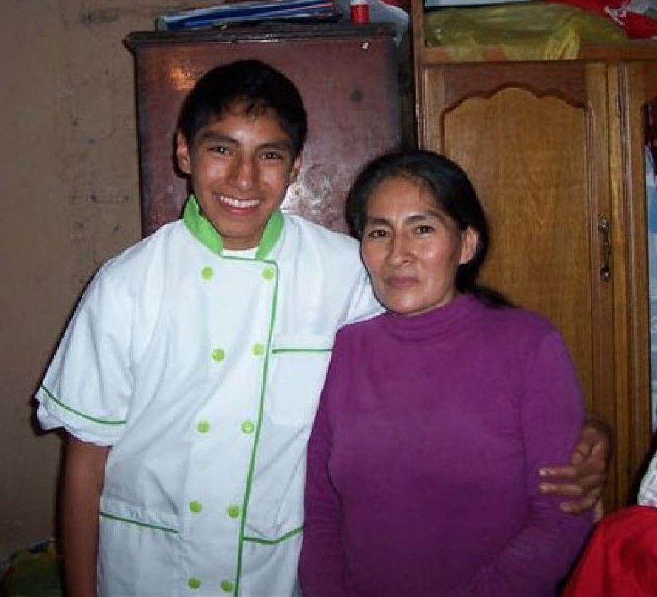 Young boy and woman standing next to each other.