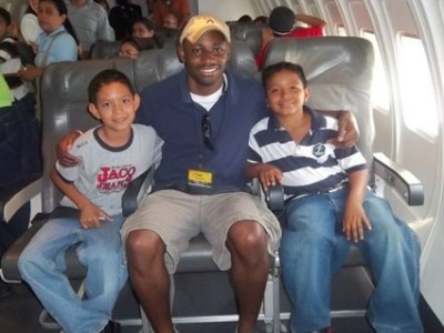 A man with two children sitting on a plane