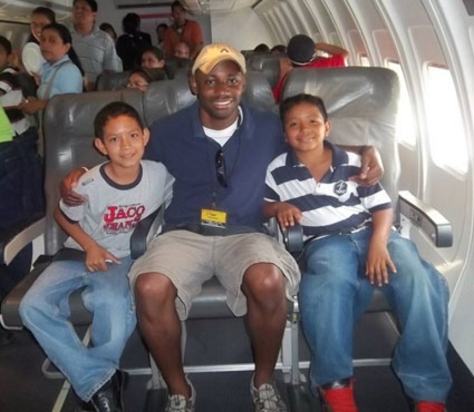 A man with two children sitting on a plane