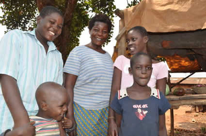 Man woman and three children standing outside.