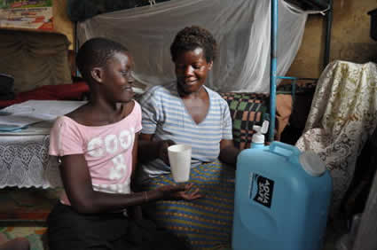 Two women looking at a cup.