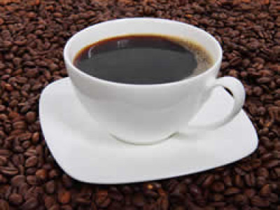 a white cup and white saucer filled with coffee