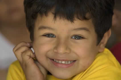 close up of young boy in yellow shirt