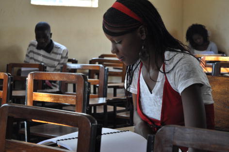 three young people studying in a classroom