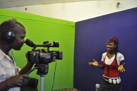young woman being video recorded by a man