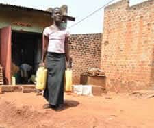 Woman carrying a water container.