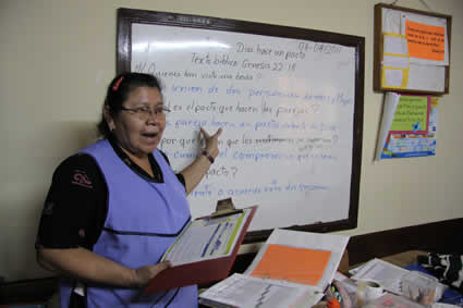 woman pointing to whiteboard