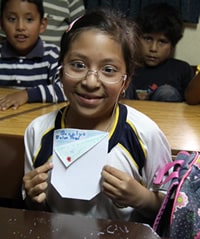 smiling girl holding a craft