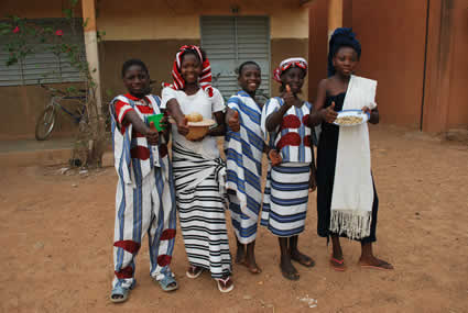 Five children standing in a line and giving the thumbs up sign