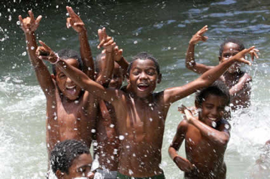 Boys-Playing-in-Water children splashing and playing in a body of water