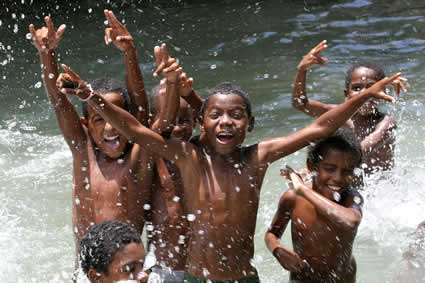 group of laughing boys playing in the water