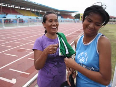 woman with girl in track uniform
