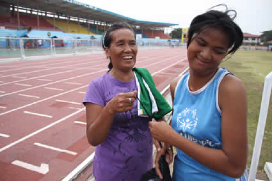 woman with girl in track uniform