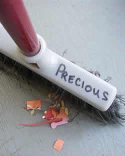 broom with the word precious written on it