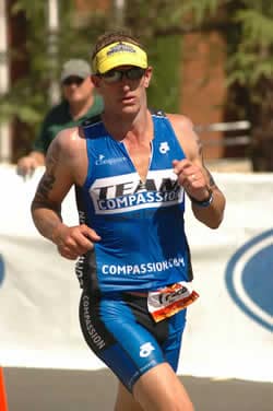 man wearing Compassion running clothes running in competition