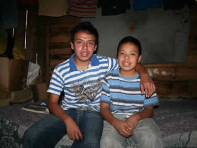 Two brothers in blue striped shirts