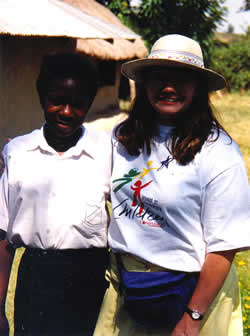 woman in hat standing next to young girl