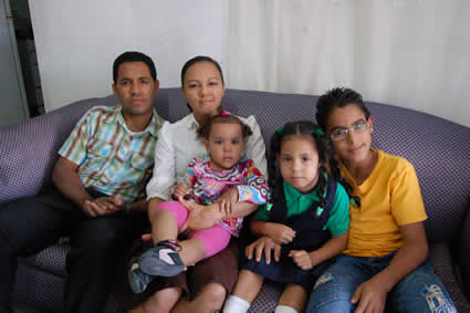 man and woman sitting with boy and two girls