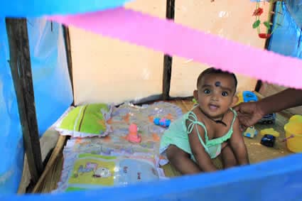 baby playing in a playhouse