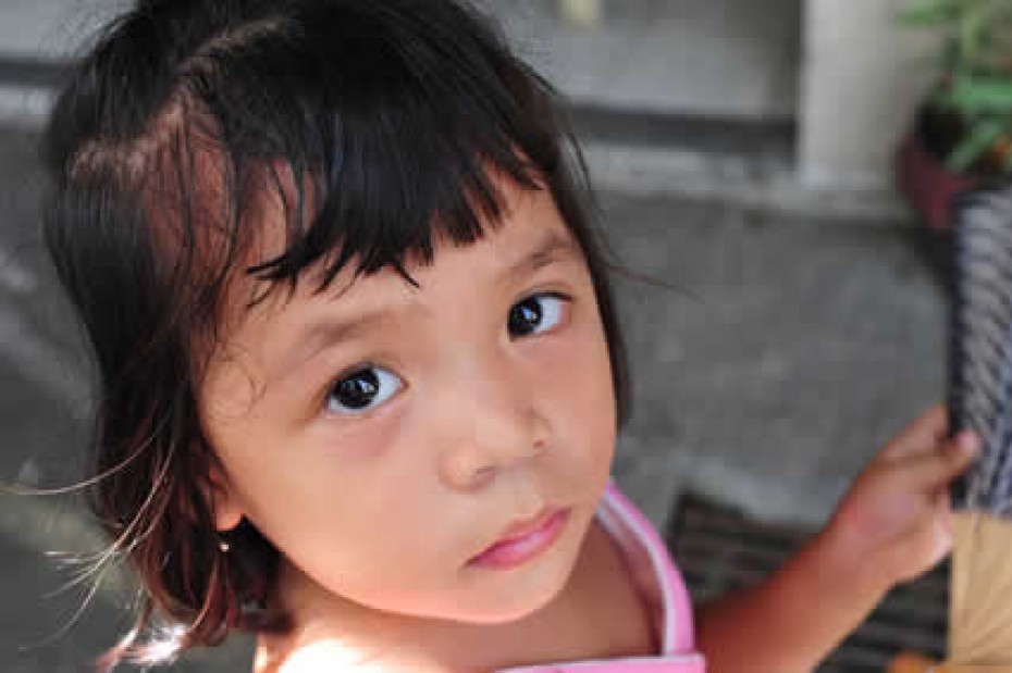 Young girl looking up into the camera.