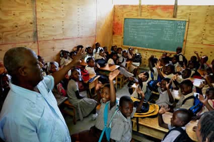 man teaching children in classroom