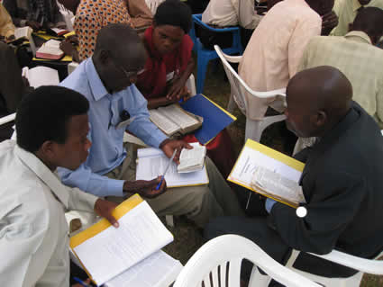 Several pastors sitting around a table.