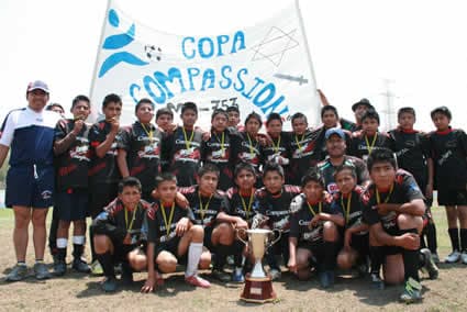 soccer team with soccer trophy