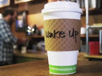 Coffee cup with wake up written on it.