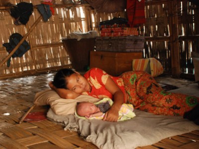 mother and baby on floor of home