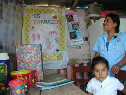 child and a young woman inside a classroom