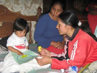 two women with a child looking at a paper