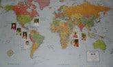 world map with children's photos attached
